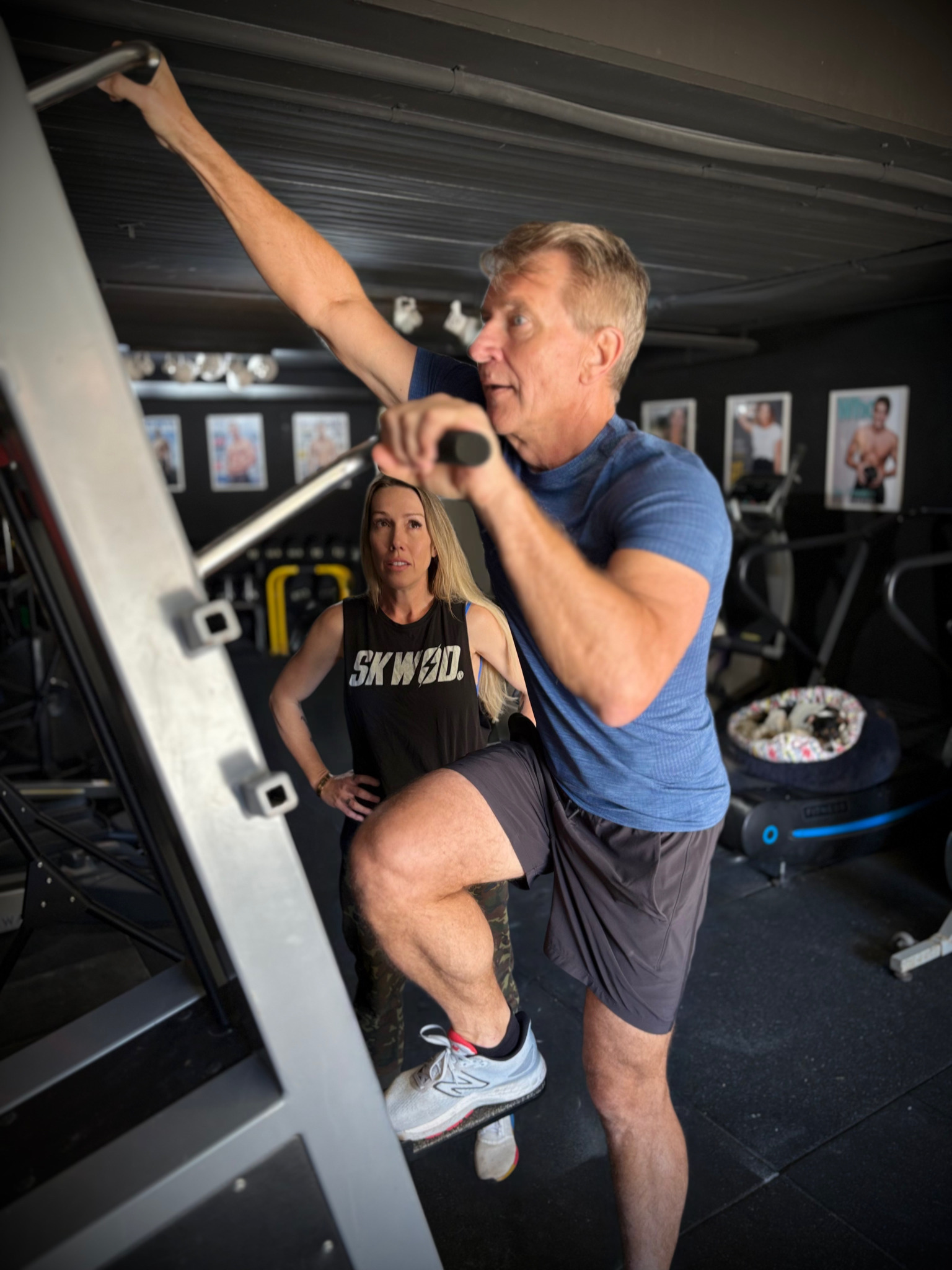 Emilie Brabon-Hames coaching Robert Herjavec on the climbing machine